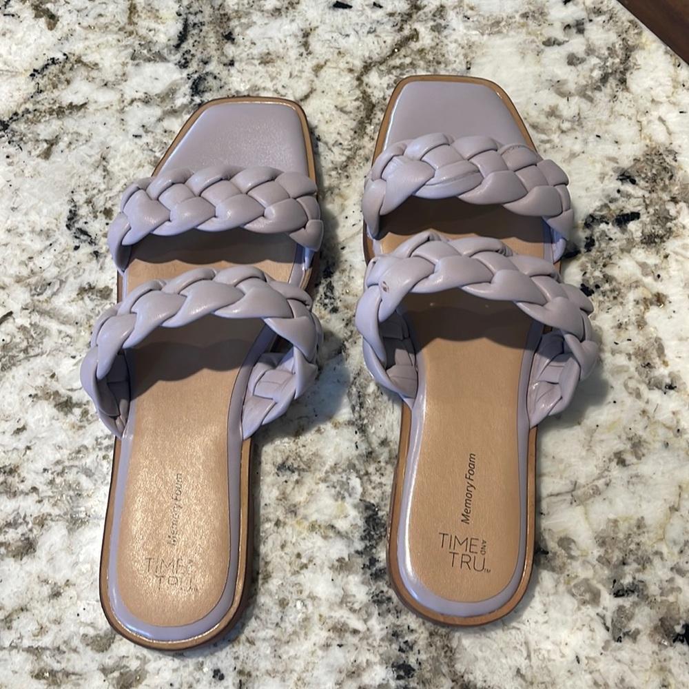 Lavender double strap flip flops. Never worn. Tiny flaw in right shoe. Size 9